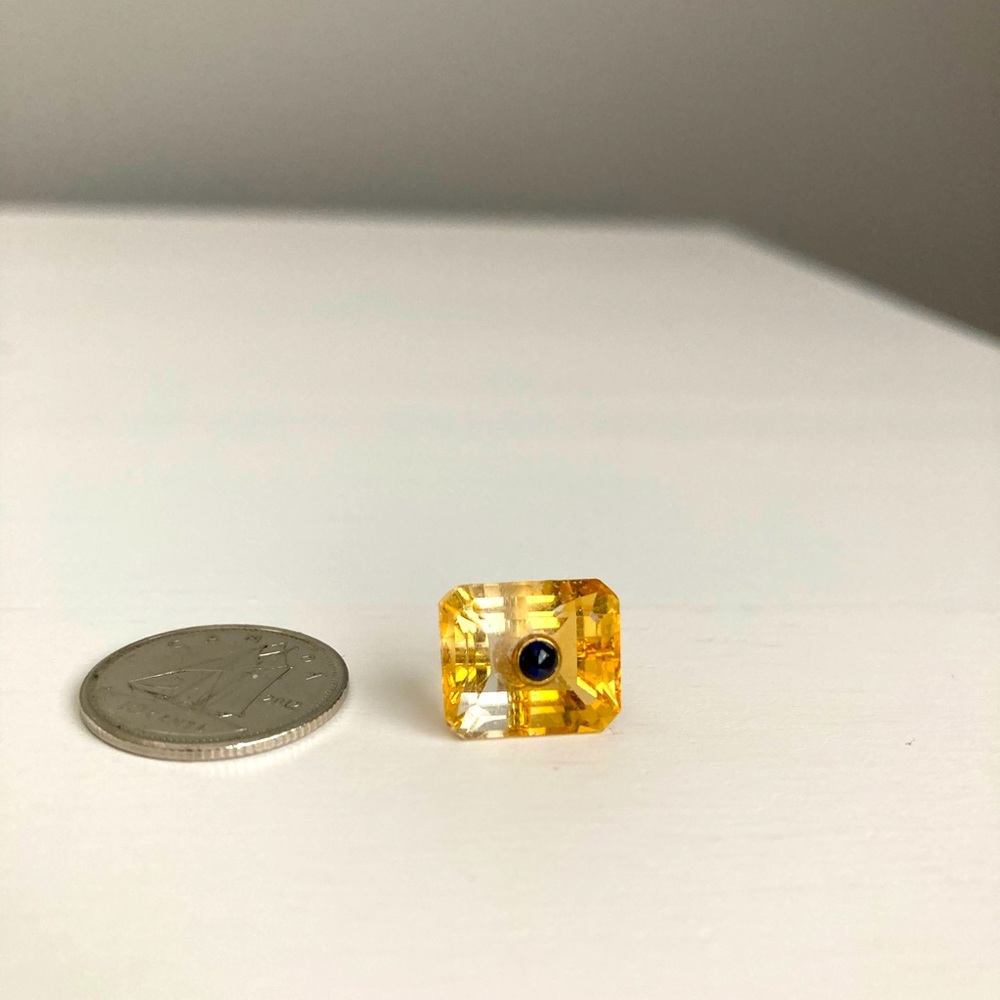 Citrine charm with small onyx inset.